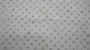 Alphabet fabric tan background